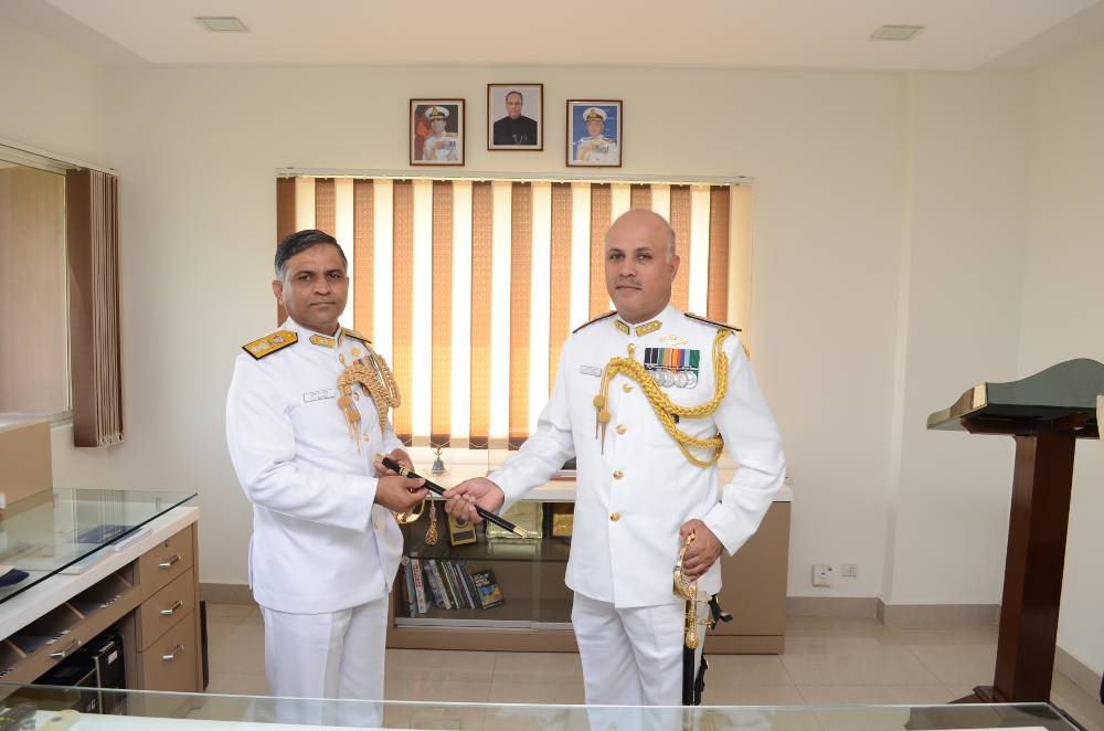 Rear Admiral SV Bhokare handing over the traditional baton to Rear Admiral Sanjay Mahindru