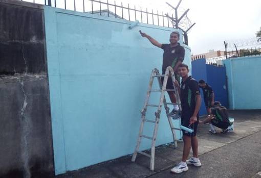 Ship's Crew painting the Gates of the Shelter Home