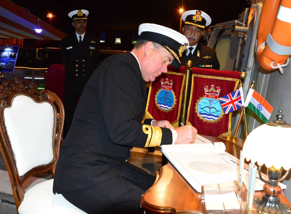 Rear Admiral Clink (FOST) signing the visitor's book at Reception