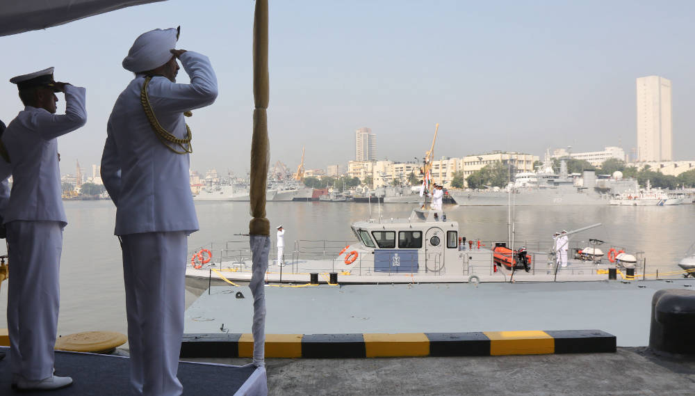 Vice Adm SPS Cheema, Flag Officer Commanding-in-Chief Western Naval Command saluting the National Flag